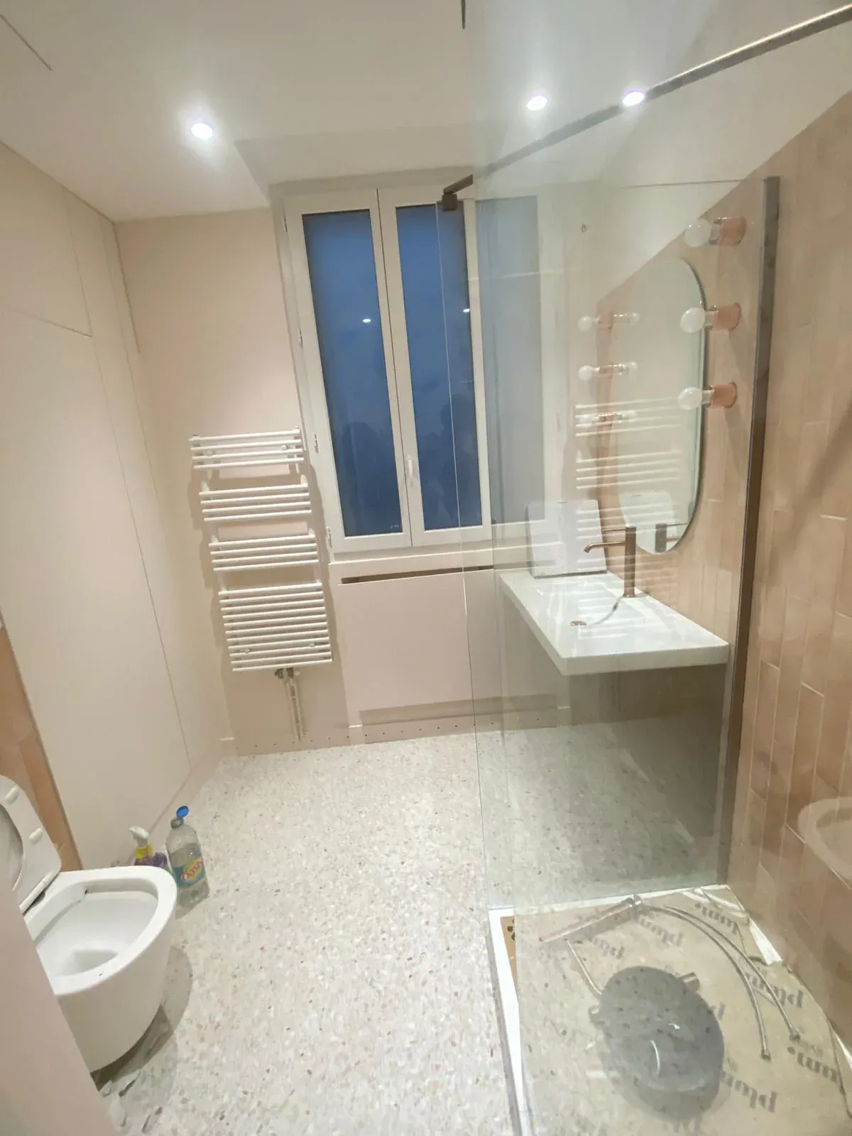 Salle de bain moderne sol terrazzo, vasque blanche et robinetterie or — Les Artistes